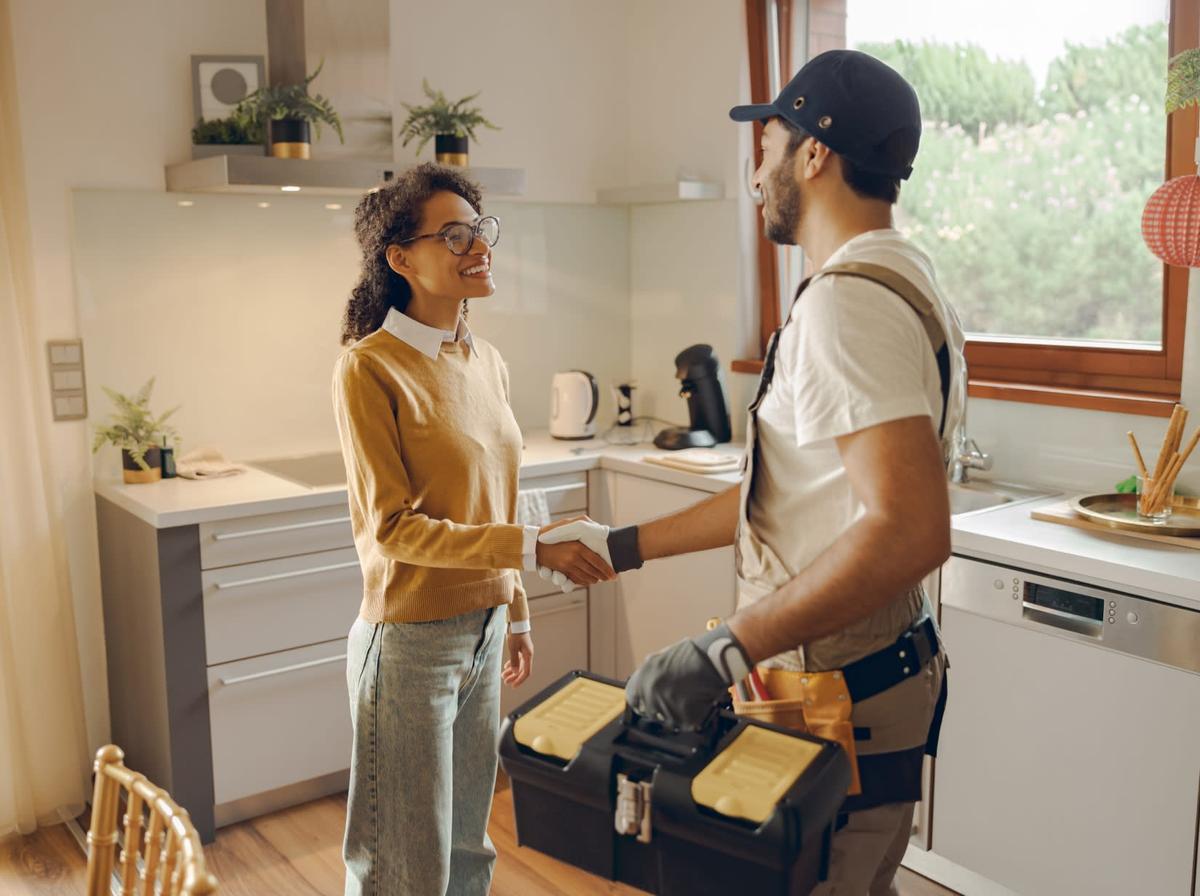 Someone greeting a technician who is holding a toolbox