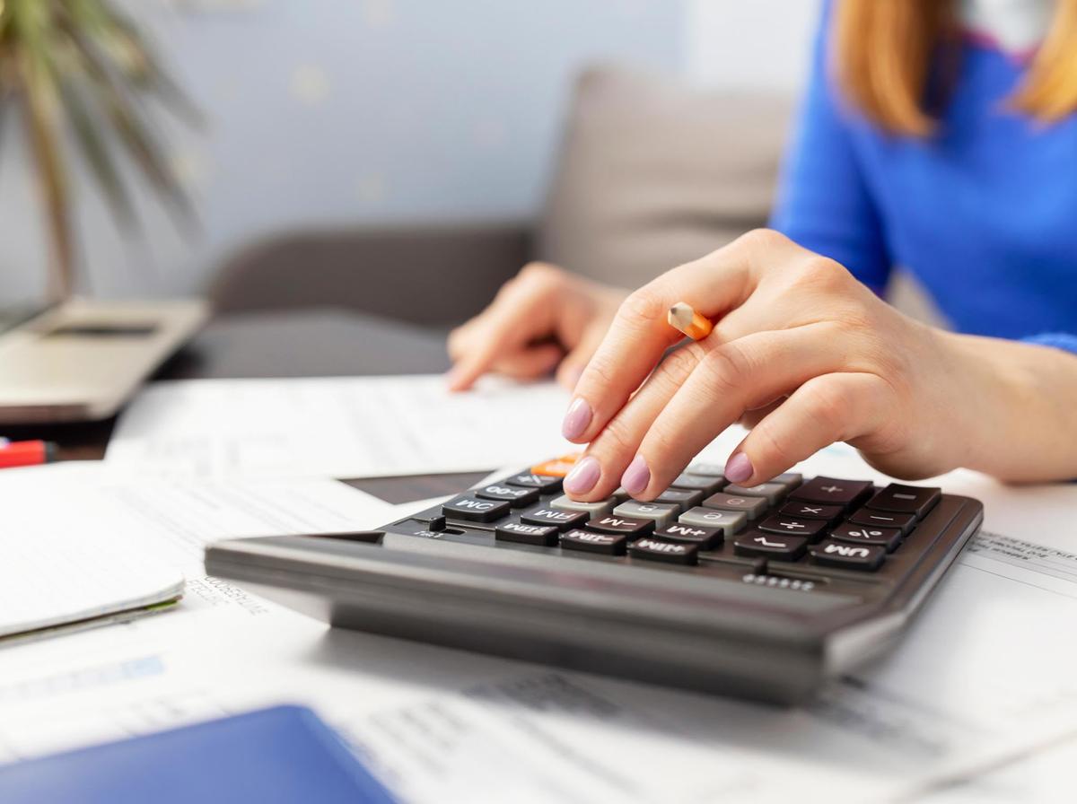 Someone using a desktop calculator