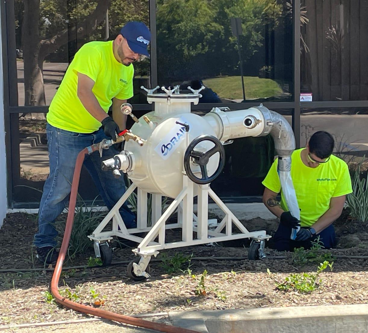 Two technicians applying the eDrain process