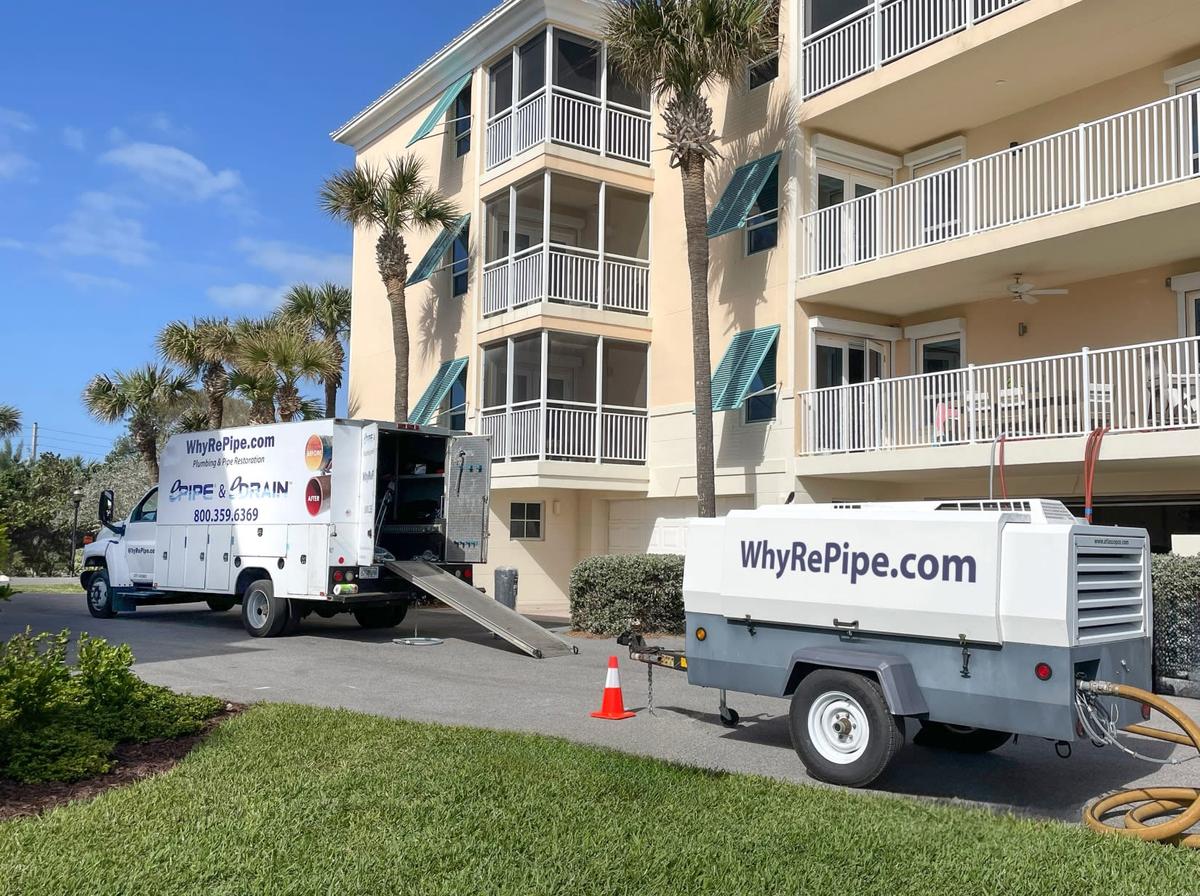 A truck and mobile generator outside a residential building