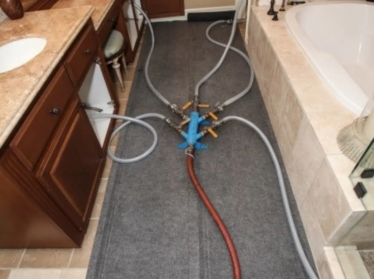 The interior of a bathroom with repiping services being completed